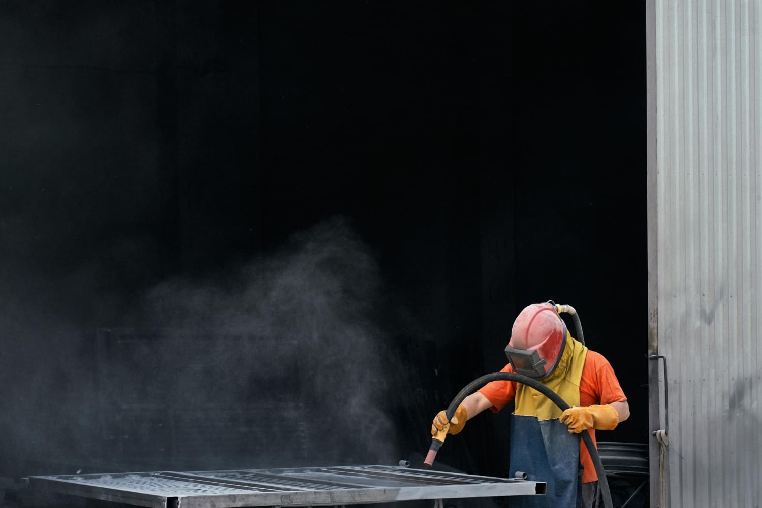 Shot blasting technician at work